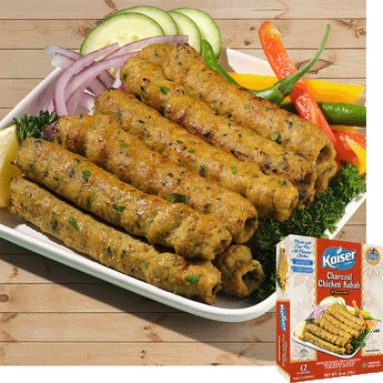 10 Kaiser Charcoal Chicken Kababs are arranged in a stack 5 on 5 on a plate with sliced, cucumber, red onion, peppers and leafy greens. A package of Kaiser Charcoal Chicken Kababs is overlaid in the bottom right corner.