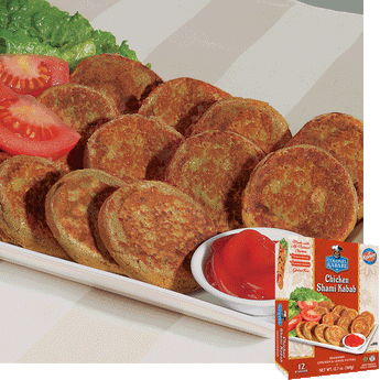 Chicken shami kababs sitting on a rectangular plate. On the back of the plate rest slices of tomato and a leaf of lettuce, on the front of the plate is small bowl with a red condiment. in the bottom right hand corner is a picture of the product package
