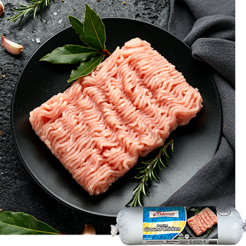 Ground chicken on a black plate with herbs, branded packaging in the corner.