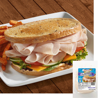 A turkey breast sandwich with cheese, cucumbers, tomato and leafy greens with potato frys on a white plate. A package of Midamar Turkey Breast is overlaid in the bottom right corner.
