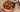 Top down image of a small bowl of chop suey, made with tender carrot, snow peas, bok choi and celery, mixed in a sauce with juicy chunks of Halal chicken.
