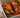 Top down shot of juicy halal grilled chicken served on a bed of sliced baked tomato, onion, peppers, and fresh basil. Served with sliced sourdough and ricotta cheese.