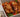 Top down shot of juicy halal grilled chicken served on a bed of sliced baked tomato, onion, peppers, and fresh basil. Served with sliced sourdough and ricotta cheese.