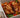 Top down shot of juicy halal grilled chicken served on a bed of sliced baked tomato, onion, peppers, and fresh basil. Served with sliced sourdough and ricotta cheese.