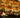 A tray of sliders filled with homemade pizza sauce, melty cheese, and meaty beef topping and beef pepperoni, coated in garlic butter and baked to a perfect golden brown.
