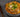White ornate bowl filled with kimchi soup, made with spicy kimchi, savory Halal chicken, broth, and tender glass noodle. Topped with sesame seeds and green onion.