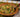 A brown decorative bowl filled with tender pasta coated in a decadently creamy sauce, peas, and diced Halal beef bacon.