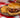 A juicy Halal Burger stuffed with jalapeno, cheese, Halal beef bacon, and cream cheese, served alongside cool, creamy elote corn salad.