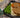 Two golden brown Halal chicken patties, topped with homemade brown gravy and served over creamy homemade mashed potatoes with organic green beans