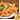 Beef Mini Samosas and Pack, garnished with peppers and lettuce, in the bottom right hand corner an image of the product box is overlaid
