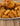 a platter showing midamar's halal breaded chicken tenders, nuggets, and patties. The patty is sat on a bun with lettuce and tomatoes