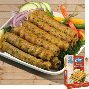 10 Kaiser Charcoal Chicken Kababs are arranged in a stack 5 on 5 on a plate with sliced, cucumber, red onion, peppers and leafy greens. A package of Kaiser Charcoal Chicken Kababs is overlaid in the bottom right corner. 