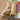 2 kati rolls made with chicken kebabs and wrapped in paratha are on a plate with a bowl of green chutney sitting behind them some rings of red onion are next to the rolls. 