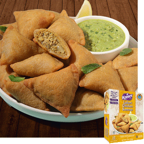 Kaiser Lahori Chicken Samosas in a pile on a white plate with some mint leaves. A bowl of chutney sits next to the pile. One samosa is cut in half and a minced meat mixture is visible inside. A package of Kaiser Lahori Chicken Samosa is overlaid in the bottom right corner.