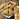 A white plate with crispy chicken samosas resting on a bed of lettuce. The samosas are garnished with a slice of radish and served with a bowl of reddish orange sauce, in the bottom right hand corner is an image of the product packaging