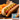 Hot dog with mustard and relish on a bun with potato chips with a package of Midamar Chicken franks