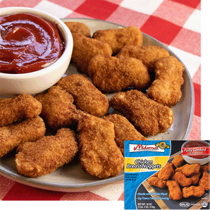 A plate of chicken nuggets stacked on a plate, a bowl of ketchup rests is on the plate to the left. A red checked cloth is under the plate. In the bottom right corner is an image of the product package