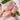Raw chicken thighs resting on parchment paper, beside them rest a garnish of herbs