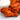 cooked chicken wings with a reddish orange sauce and a small bowl of ranch